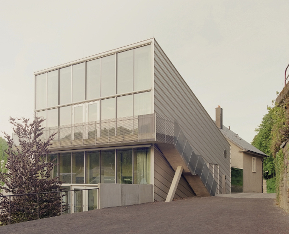 SPEKTRUM: The building engages with the landscape, offering a perspective into the lush valley, and the cement factory SPEKTRUM: The building engages with the landscape, offering a perspective into the lush valley, and the cement factory